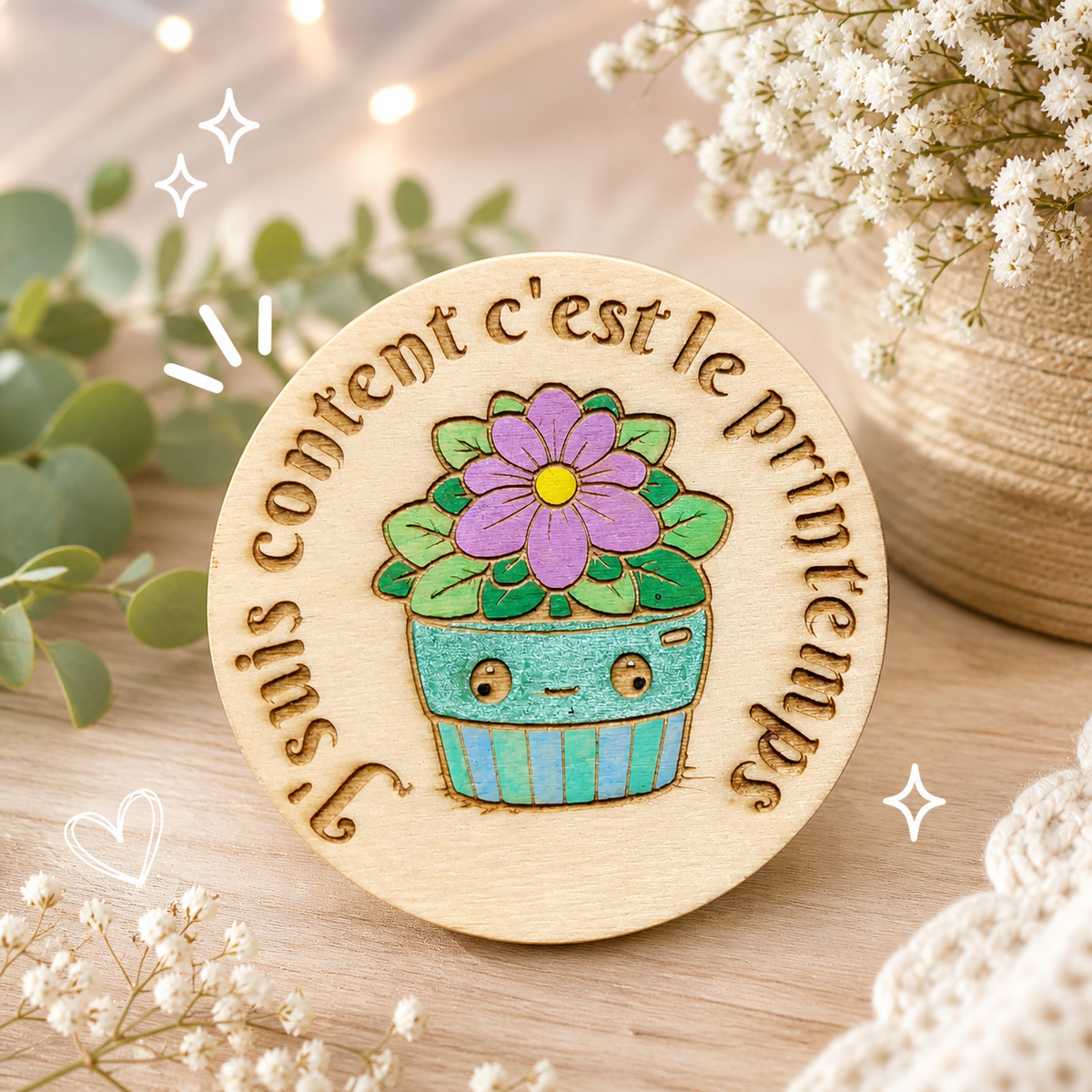 Badge représentant le mois de Mars par une plante et une phrase du printemps